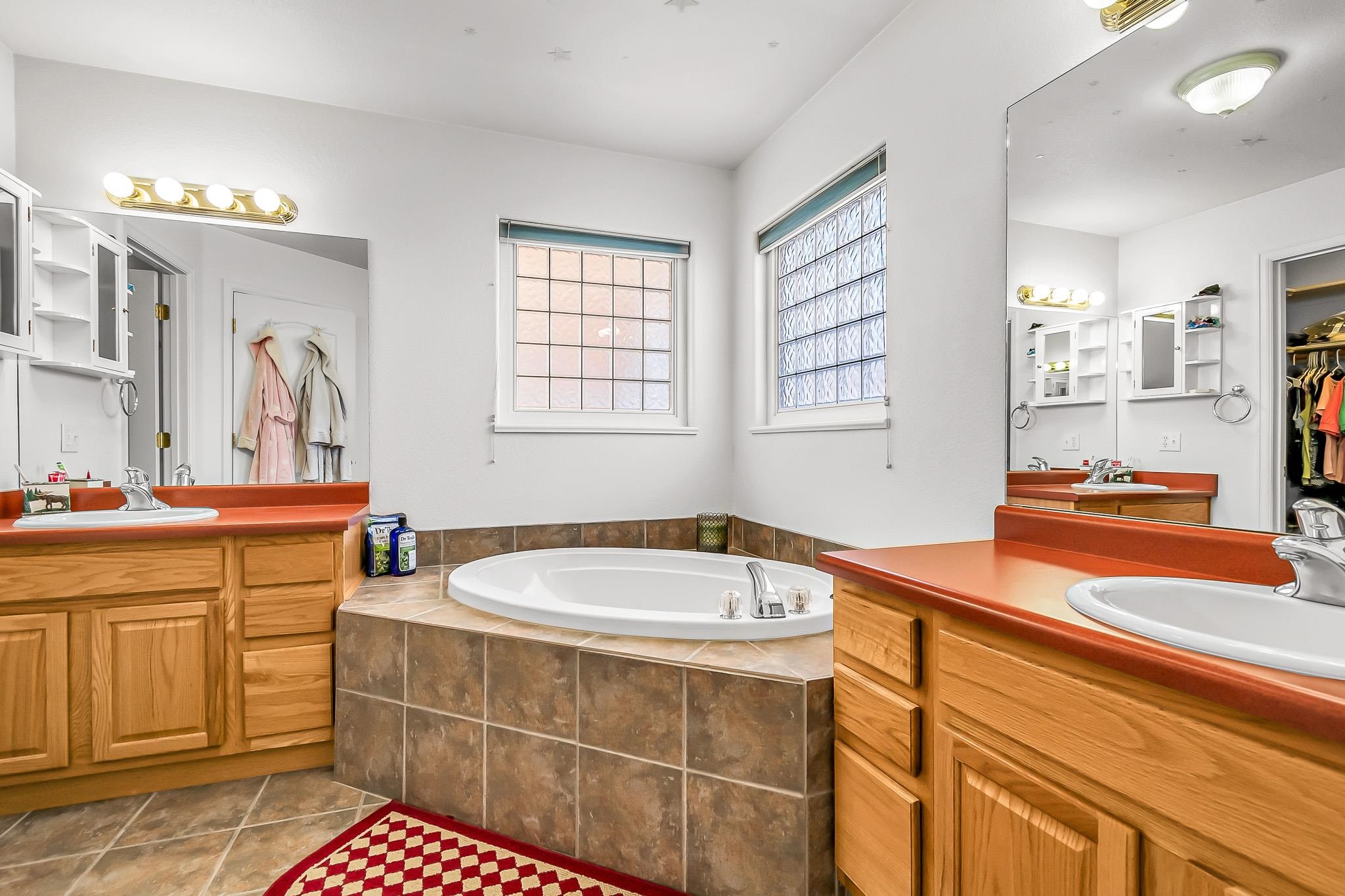 2833 B B 3/10 Road Grand Junction, CO 81503 - Photo 24 of 35 a spacious bathroom with sinks mirror and a bathtub
