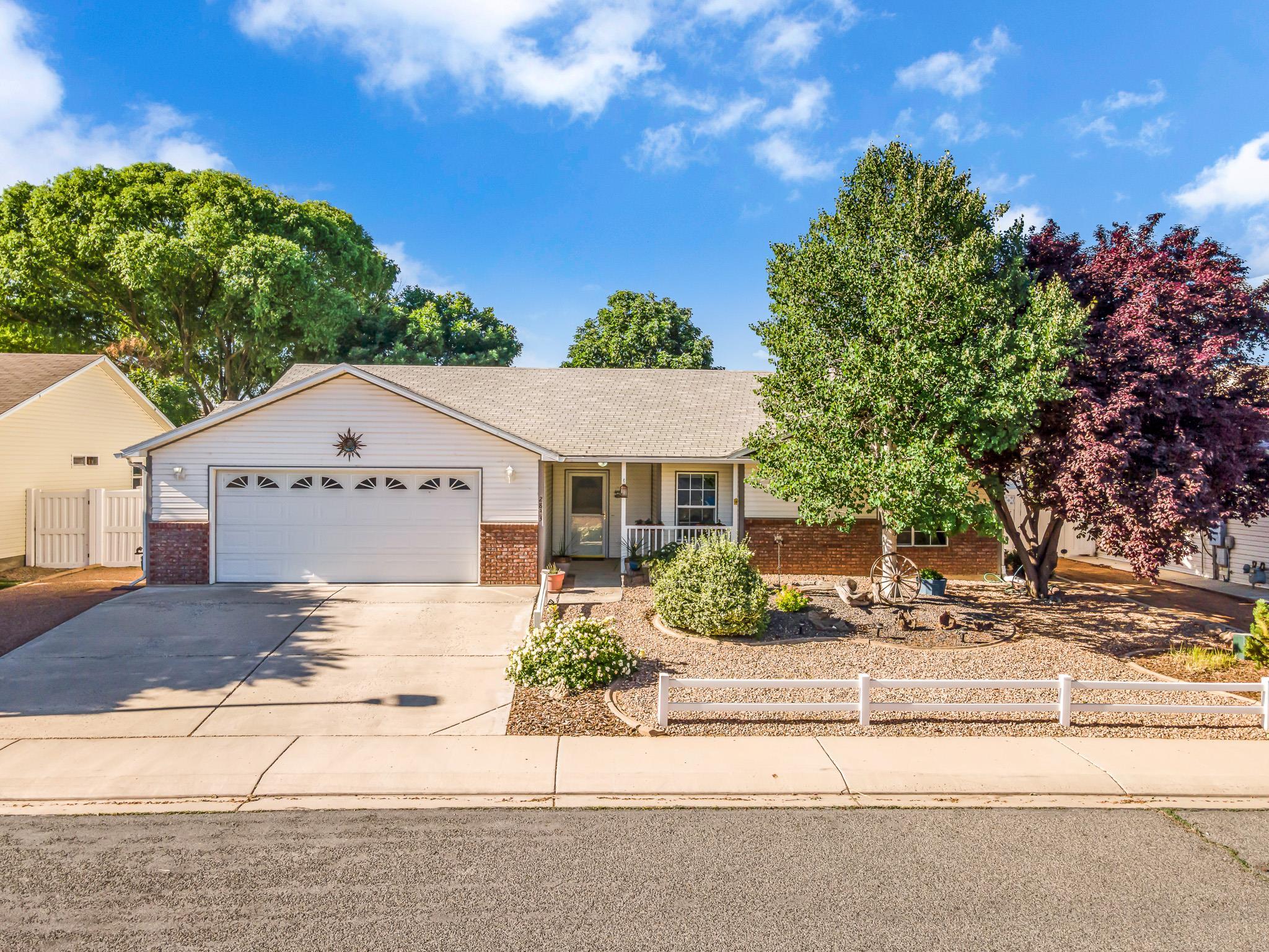 2833 B B 3/10 Road Grand Junction, CO 81503 - Photo 4 of 35 a front view of a house with a yard and potted plants