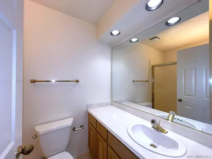 a bathroom with a sink toilet and mirror