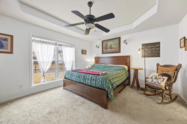 a bedroom with a bed a chair and bed