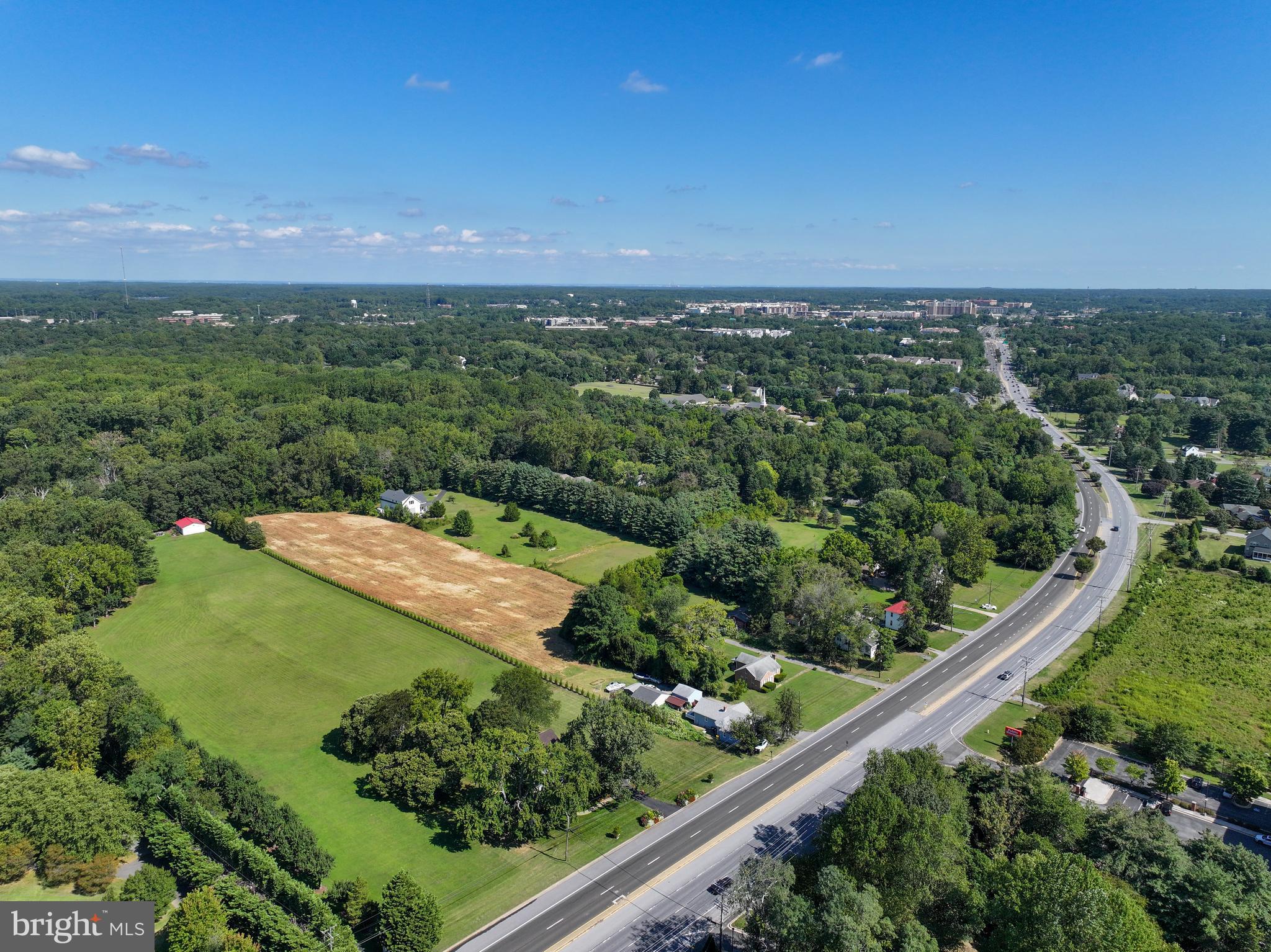 67 Wallace Manor Road Edgewater, MD 21037 - Photo 23 of 36 an aerial view of a golf course with a lake
