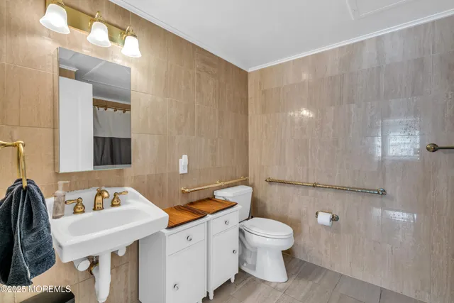 a bathroom with a sink a toilet and mirror