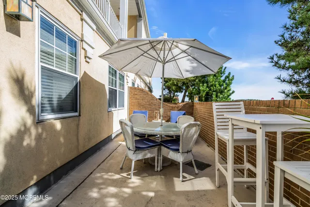 a view of a dinning table and chairs in the balcony