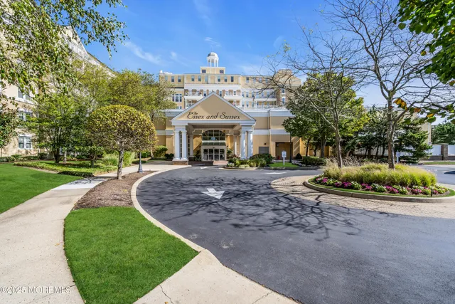 a view of a white house with a big yard and large trees