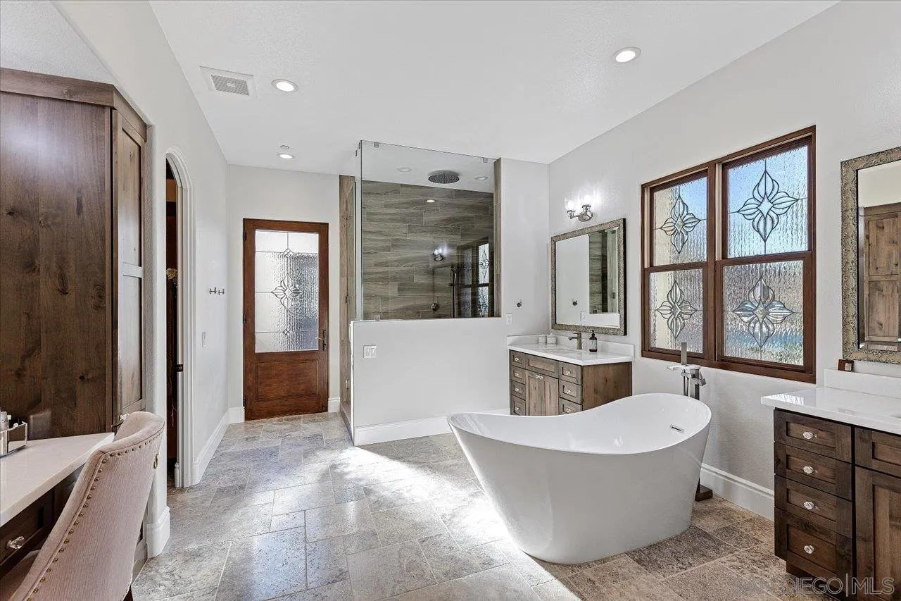 1202 Via Zamia Encinitas, CA 92024 - Photo 12 of 41 a spacious bathroom with a tub sink shower and mirror