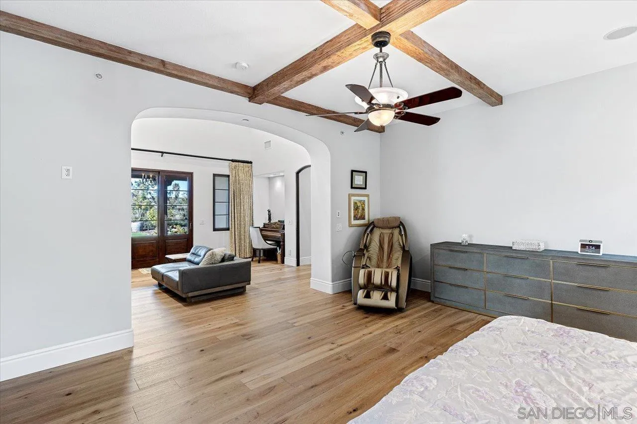 1202 Via Zamia Encinitas, CA 92024 - Photo 13 of 41 a bedroom with a bed and a chandelier