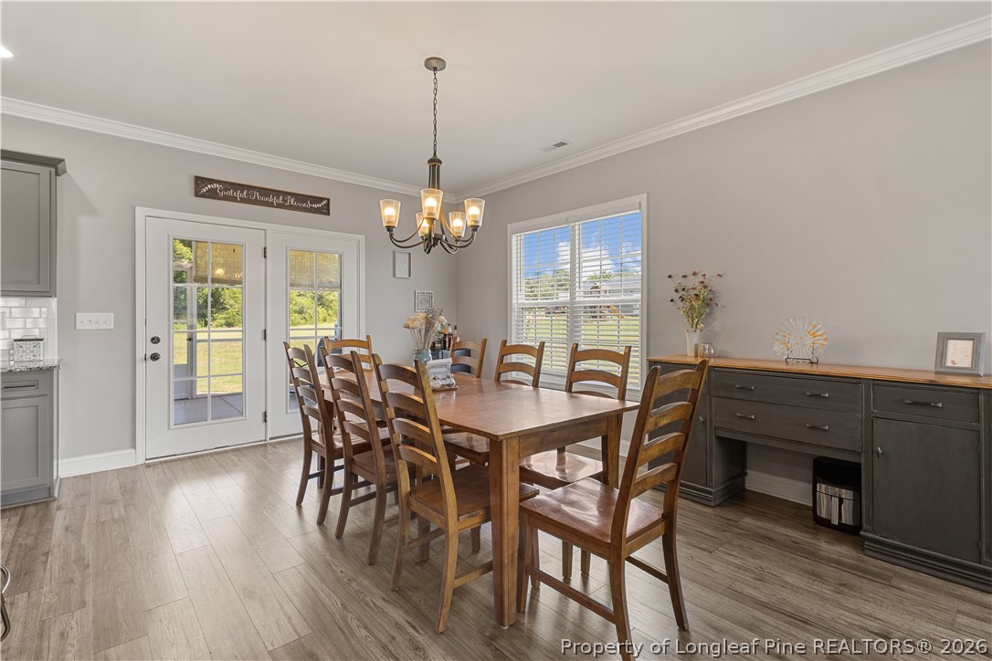 137 Minter School Road Sanford, NC 27332 - Photo 9 of 50 a view of a dining room with furniture window and wooden floor