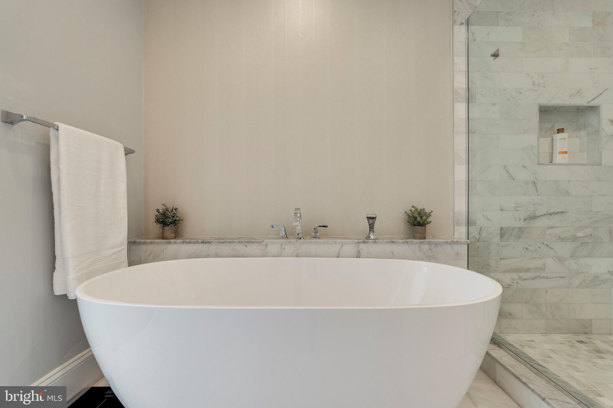 3616 T Street Northwest Washington, DC 20007 - Photo 18 of 49 a white bath tub sitting in a bathroom