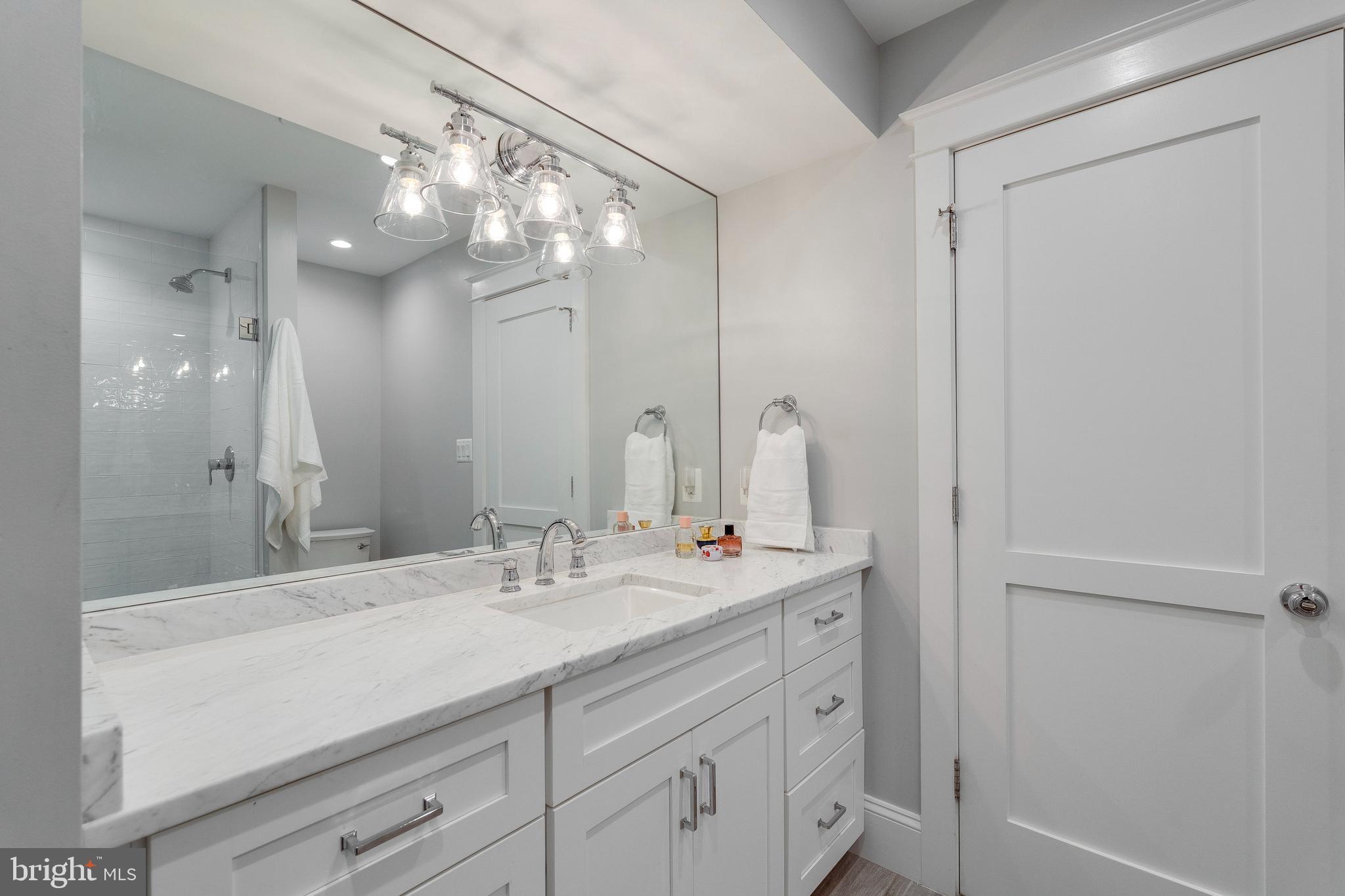 3616 T Street Northwest Washington, DC 20007 - Photo 29 of 49 a bathroom with a sink a large mirror and a shower