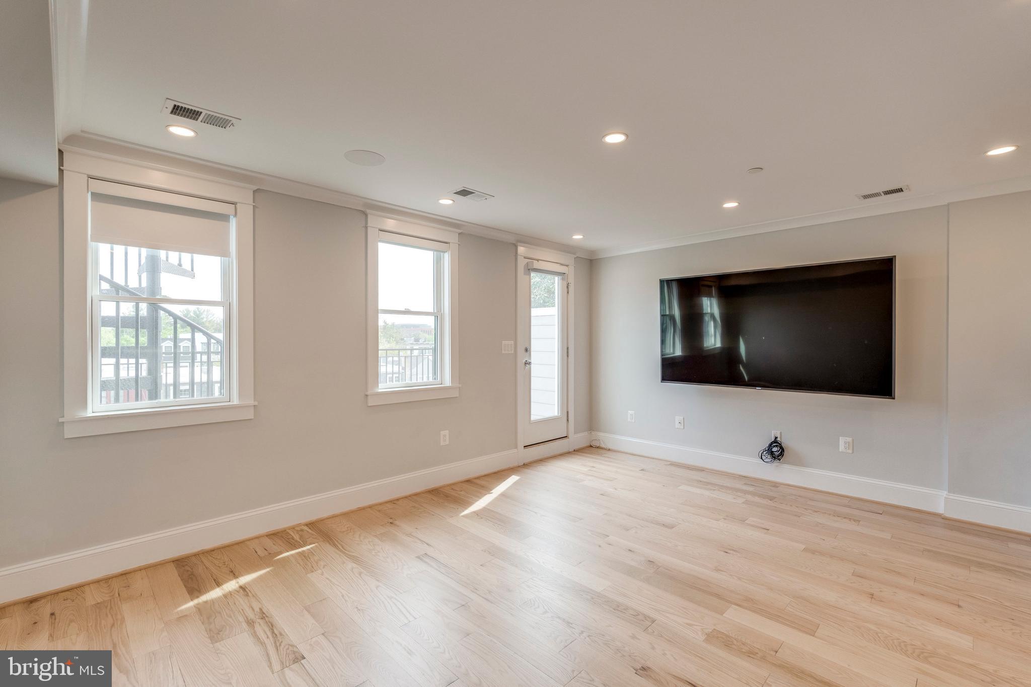3616 T Street Northwest Washington, DC 20007 - Photo 33 of 49 a view of an empty room with wooden floor and windows