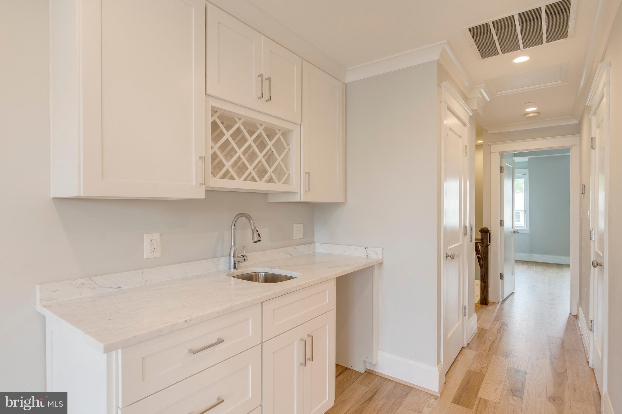 3616 T Street Northwest Washington, DC 20007 - Photo 34 of 49 a kitchen with stainless steel appliances white cabinets and a wooden floor