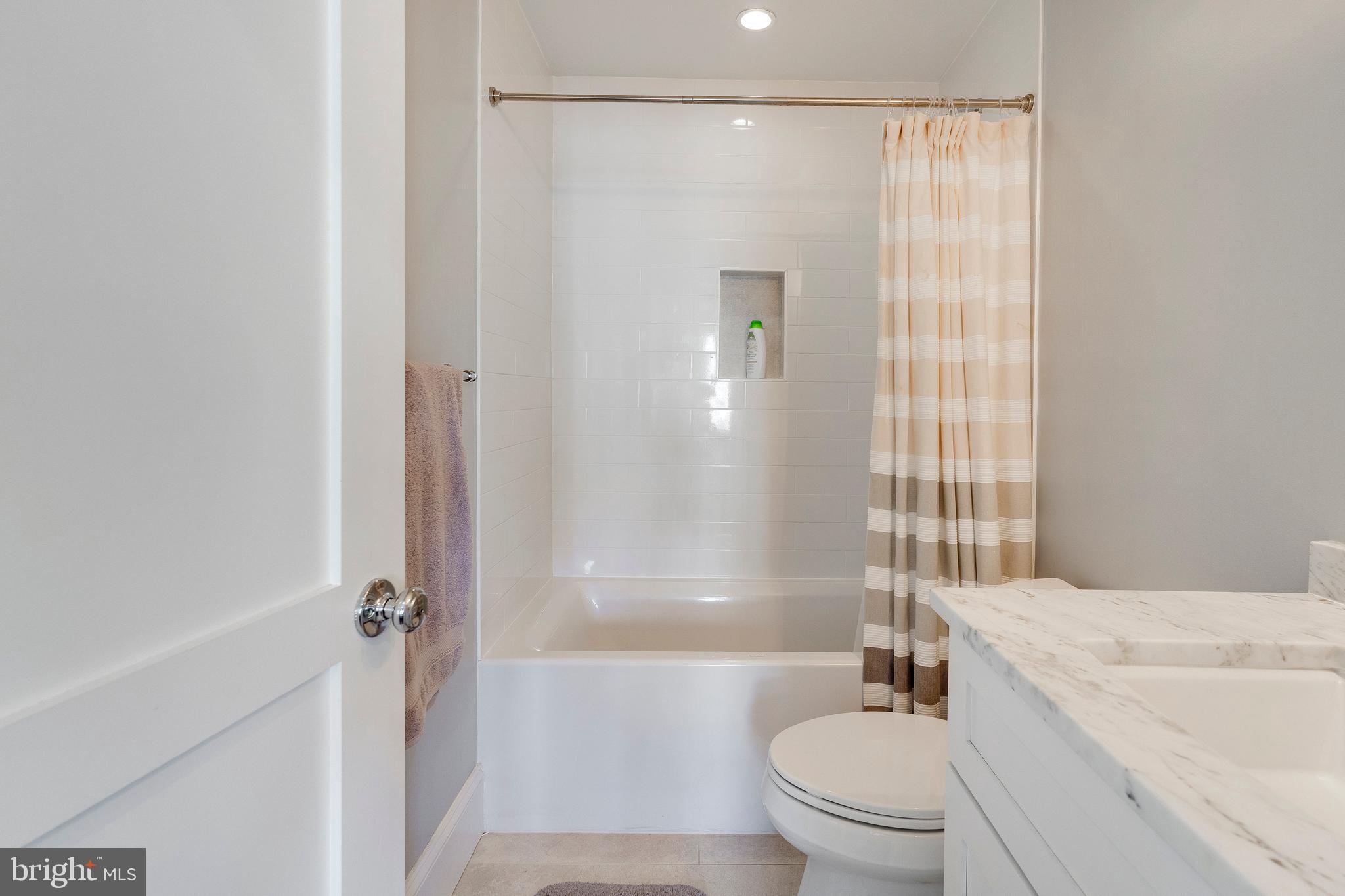 3616 T Street Northwest Washington, DC 20007 - Photo 45 of 49 a bathroom with a granite countertop bathtub shower sink vanity and toilet