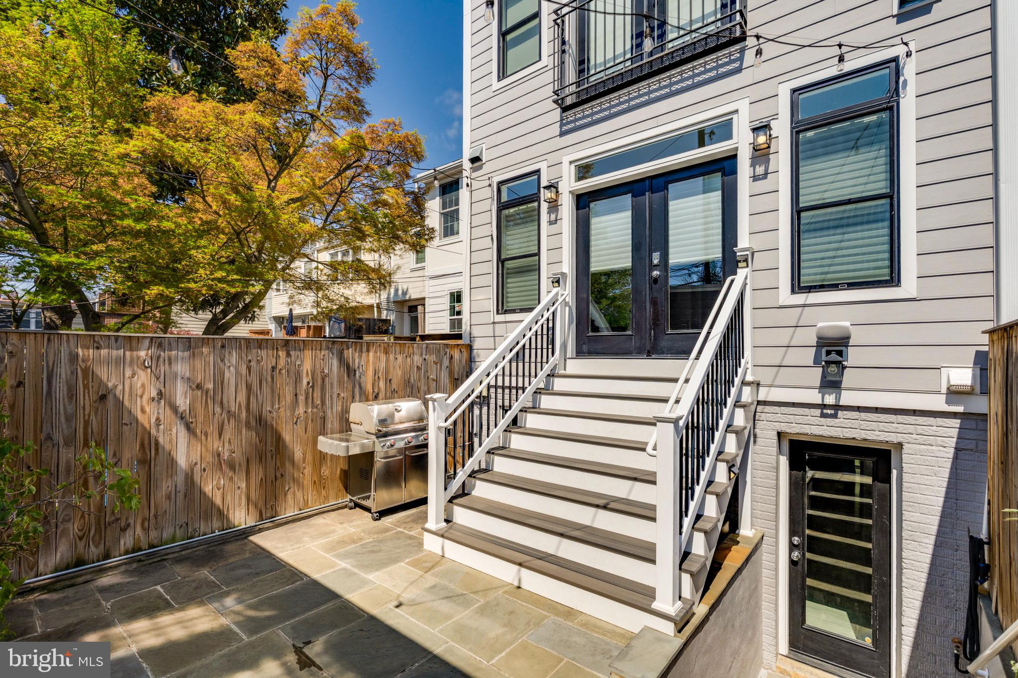 3616 T Street Northwest Washington, DC 20007 - Photo 47 of 49 a view of a patio with table and chairs with wooden fence and plants