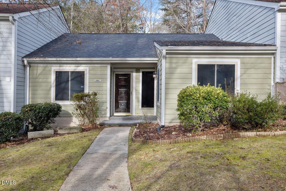 5867 Branchwood Road Raleigh, NC 27609 - Photo 1 of 24 a front view of a house with garden
