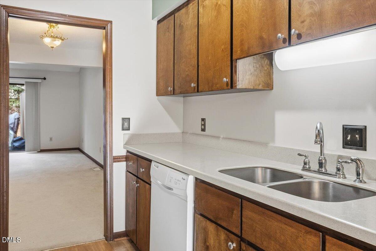 5867 Branchwood Road Raleigh, NC 27609 - Photo 10 of 24 a kitchen with a sink and cabinets