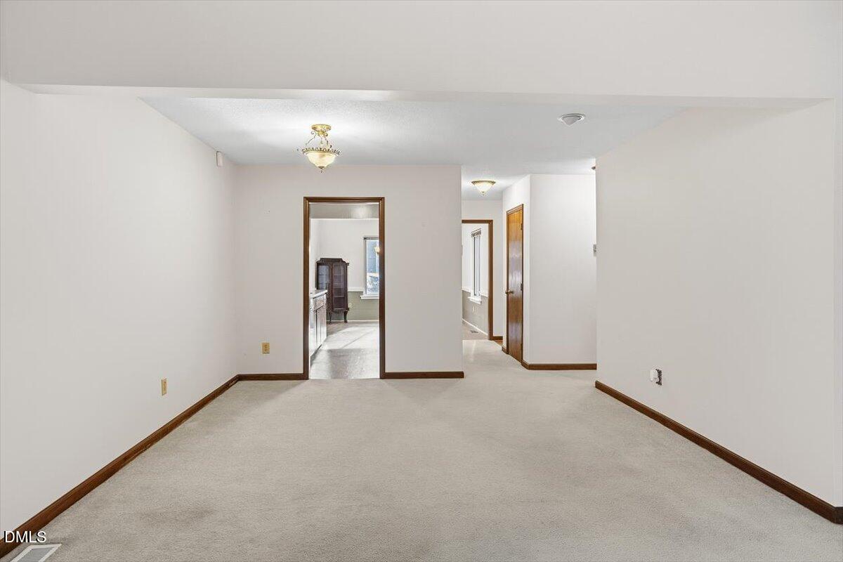 5867 Branchwood Road Raleigh, NC 27609 - Photo 12 of 24 an empty room with closet and mirrors