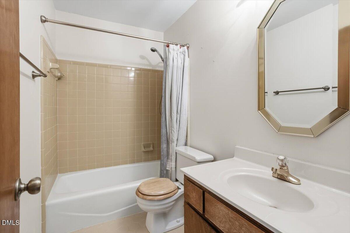 5867 Branchwood Road Raleigh, NC 27609 - Photo 18 of 24 a bathroom with a sink toilet and shower