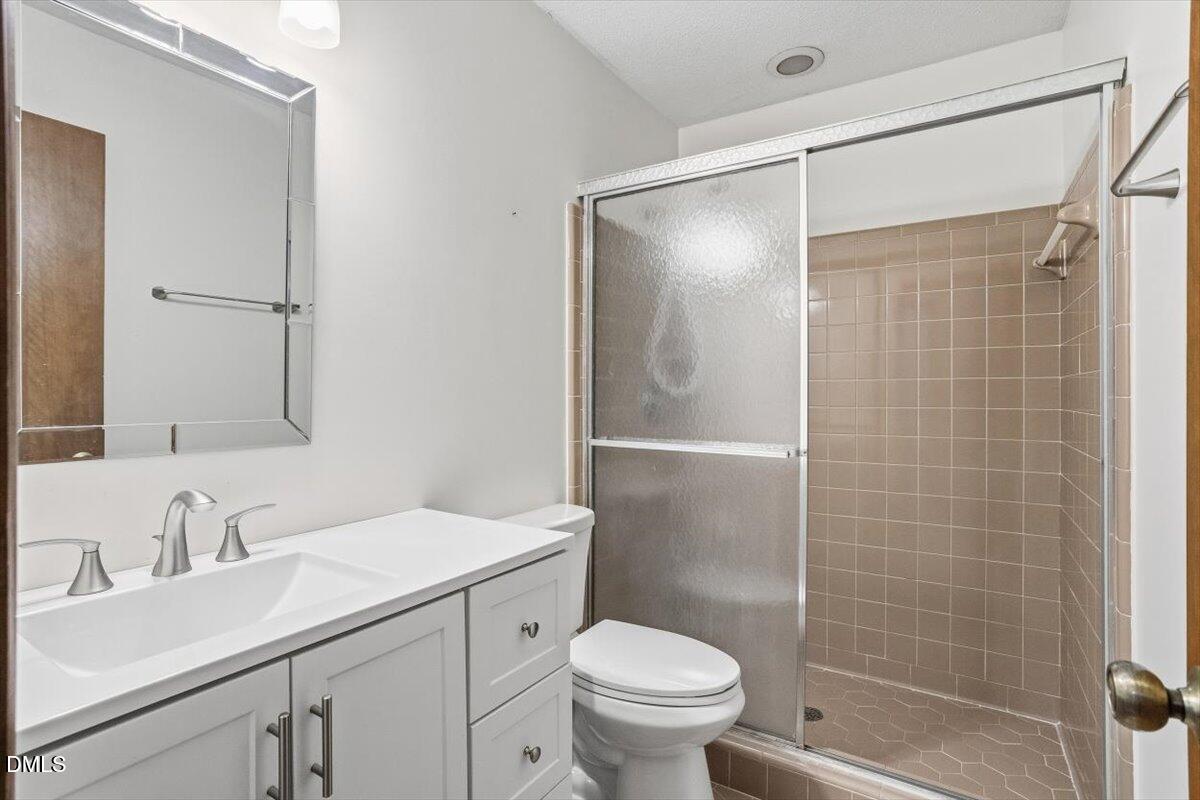 5867 Branchwood Road Raleigh, NC 27609 - Photo 20 of 24 a bathroom with a sink toilet and shower