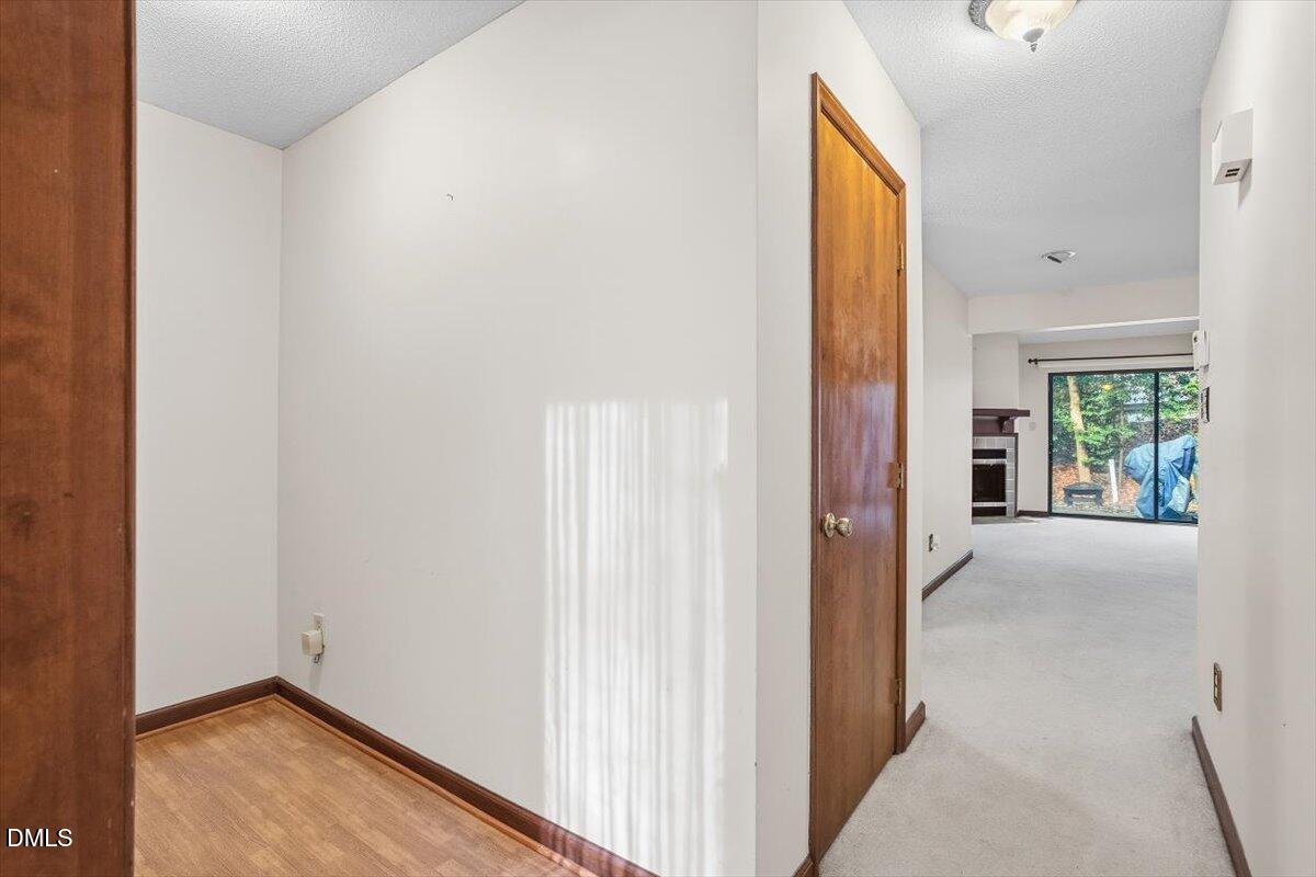 5867 Branchwood Road Raleigh, NC 27609 - Photo 5 of 24 a view of a hallway with wooden floor and windows