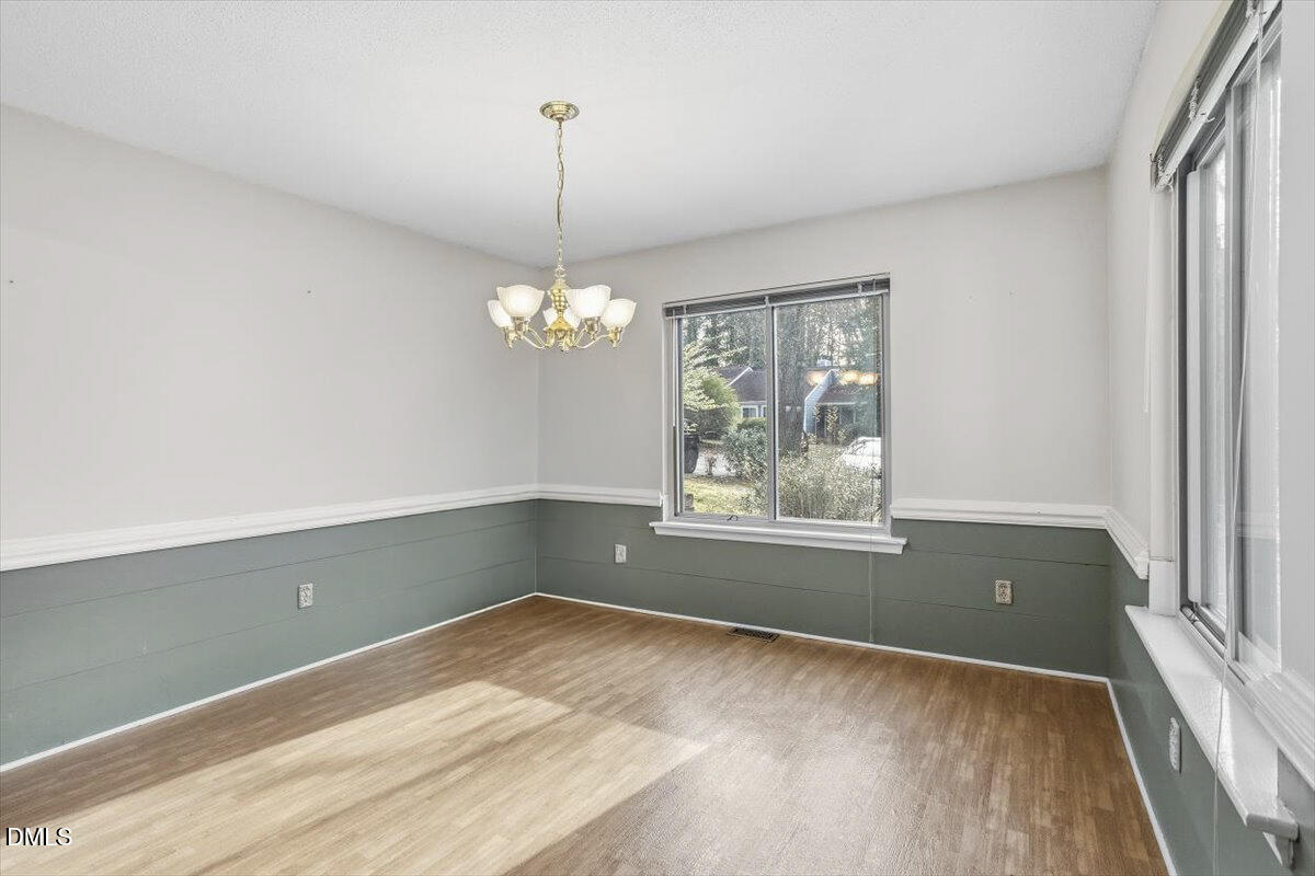 5867 Branchwood Road Raleigh, NC 27609 - Photo 6 of 24 a view of room with window and chandelier
