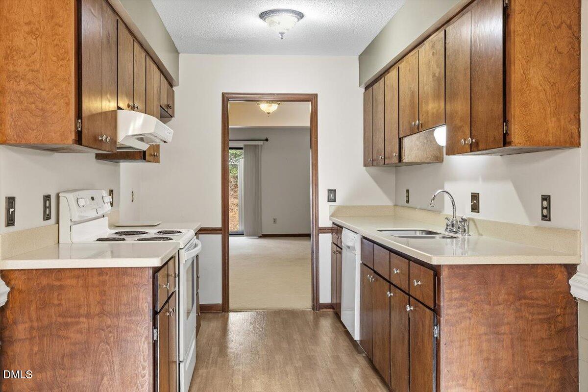 5867 Branchwood Road Raleigh, NC 27609 - Photo 8 of 24 a kitchen with stainless steel appliances granite countertop a sink stove and refrigerator
