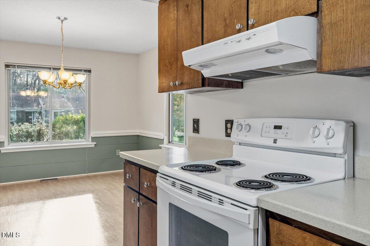 5867 Branchwood Road Raleigh, NC 27609 - Photo 9 of 24 a white stove top oven sitting inside of a kitchen