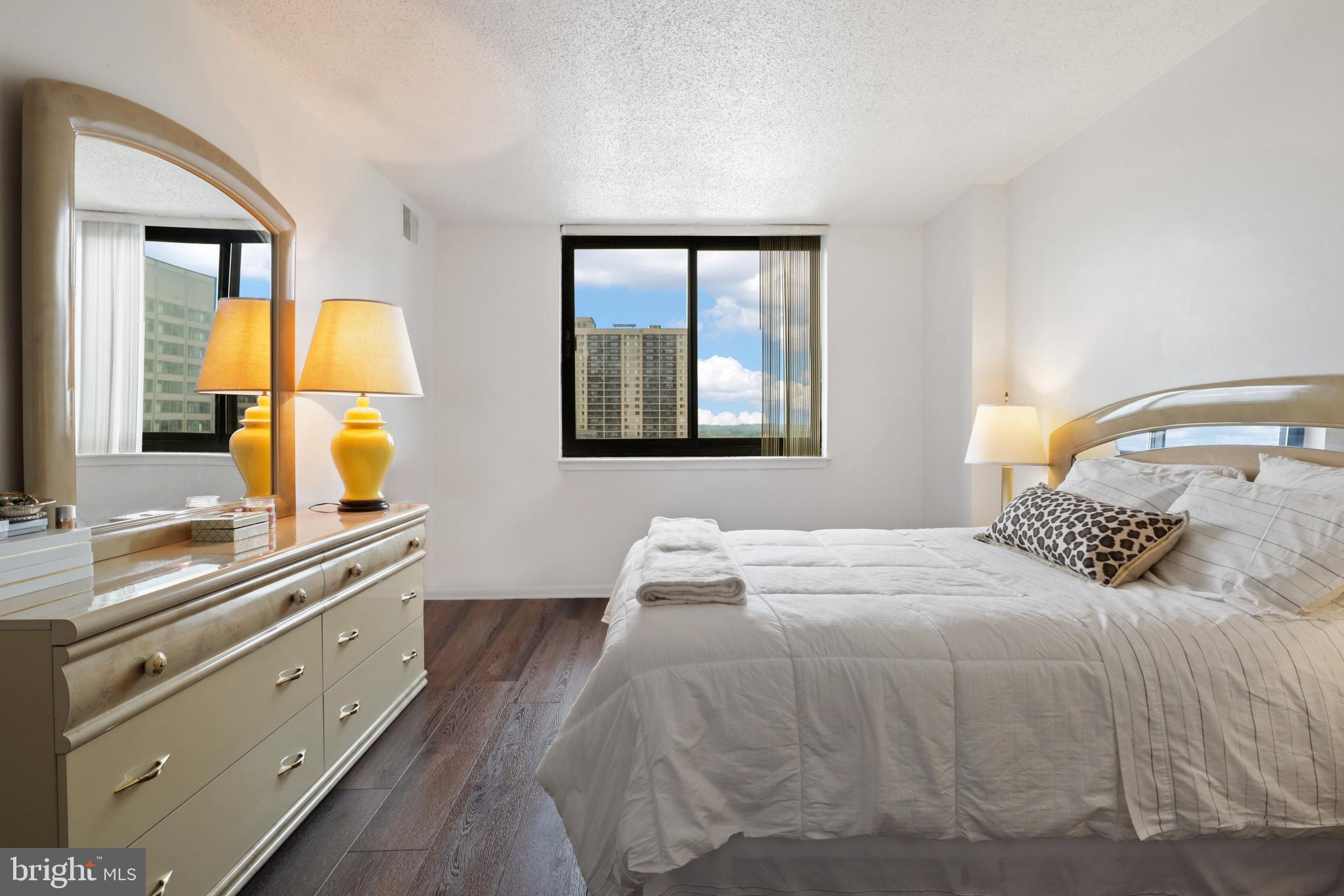 5505 Seminary Road, Unit 1306N Falls Church, VA 22041 - Photo 22 of 43 a bedroom with a bed and a dresser with mirror
