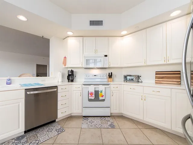 a kitchen with a sink window and cabinets