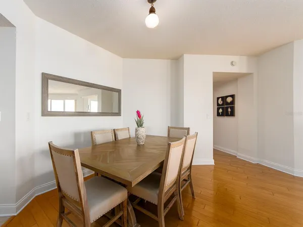 a view of a dining room with furniture and wooden floor