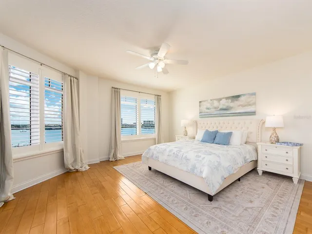 a bedroom with a large bed and a chandelier
