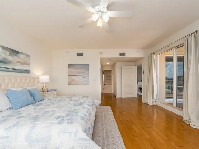 a spacious bedroom with a bed and a chandelier