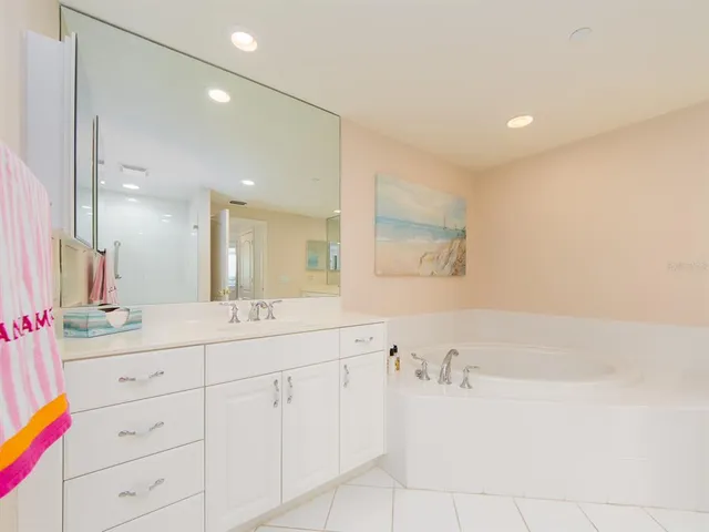 a bathroom with a bathtub sink and mirror