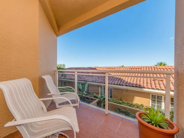 a balcony with table and chairs