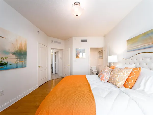 a bedroom with a bed and a painting on the wall