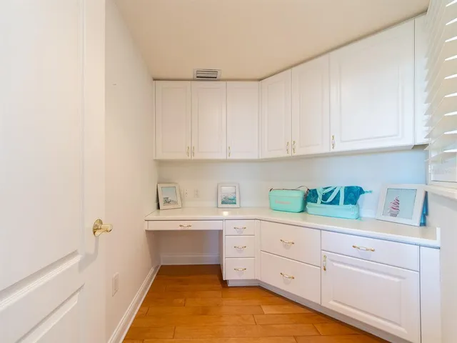 a kitchen with white cabinets and white appliances