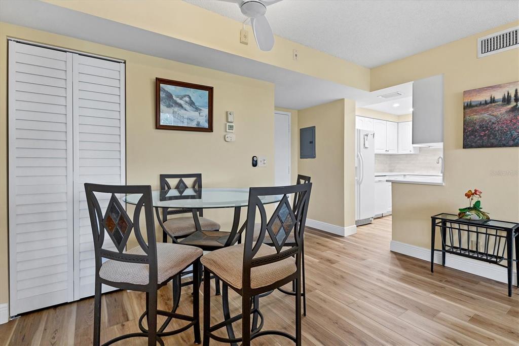 5855 Midnight Pass Road, Unit 420 Sarasota, FL 34242 - Photo 14 of 53 a view of a dining room with furniture and wooden floor