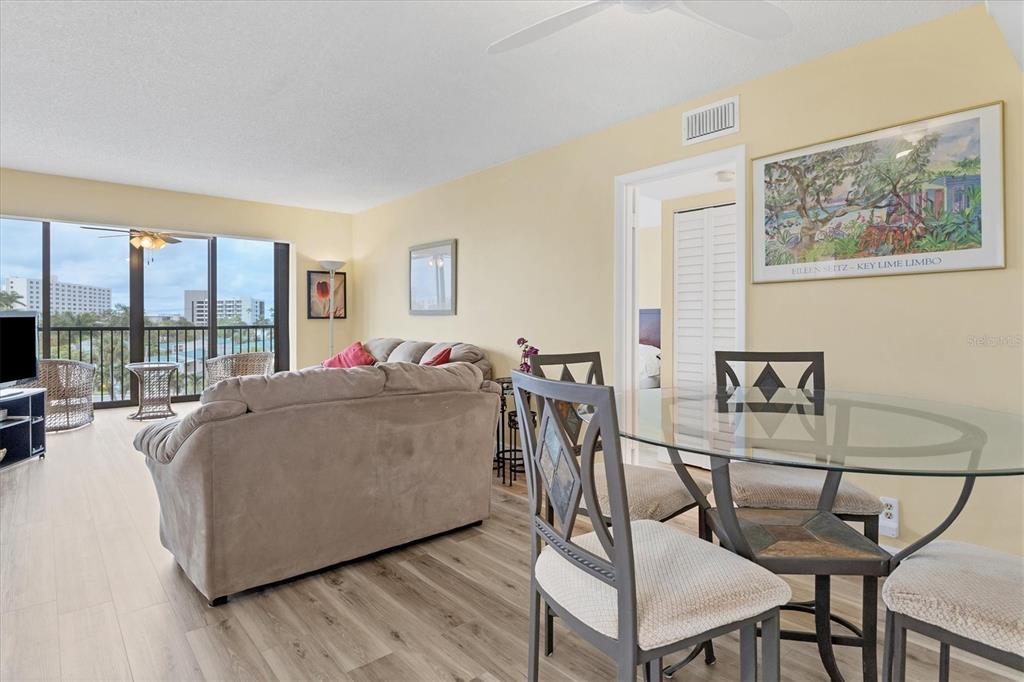 5855 Midnight Pass Road, Unit 420 Sarasota, FL 34242 - Photo 15 of 53 a living room with furniture and a floor to ceiling window