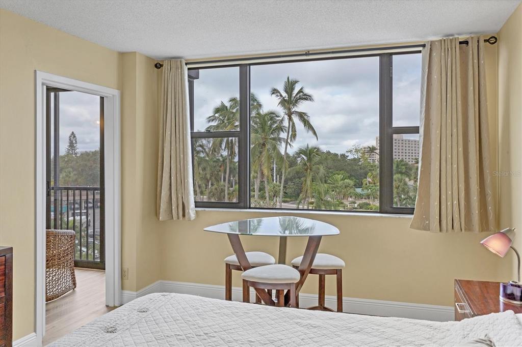 5855 Midnight Pass Road, Unit 420 Sarasota, FL 34242 - Photo 18 of 53 a view of a bedroom with furniture and windows