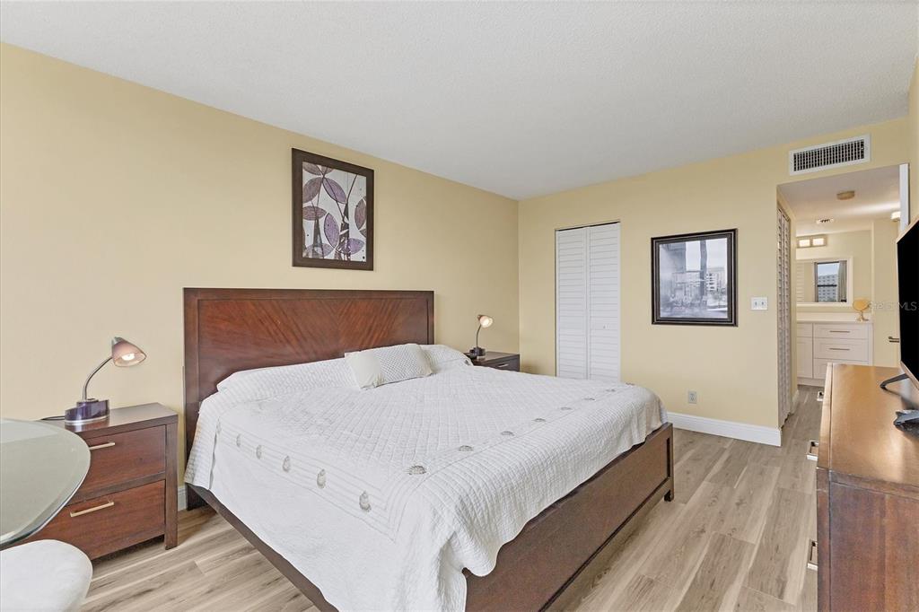 5855 Midnight Pass Road, Unit 420 Sarasota, FL 34242 - Photo 20 of 53 a bedroom with a bed and wooden floor