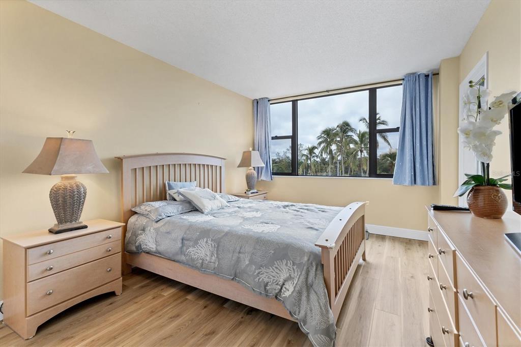 5855 Midnight Pass Road, Unit 420 Sarasota, FL 34242 - Photo 22 of 53 a bedroom with a bed and large window