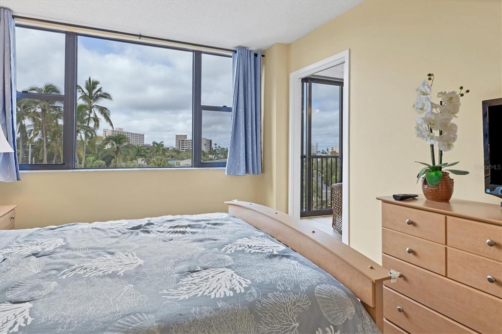 5855 Midnight Pass Road, Unit 420 Sarasota, FL 34242 - Photo 23 of 53 a bedroom with a large bed and a window