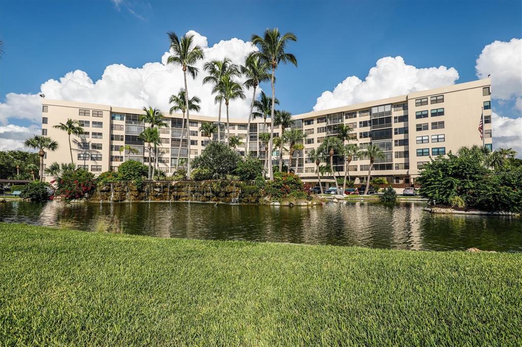 5855 Midnight Pass Road, Unit 420 Sarasota, FL 34242 - Photo 30 of 53 a view of a lake with a building in the background