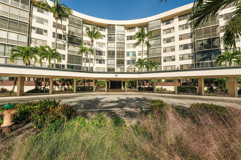 5855 Midnight Pass Road, Unit 420 Sarasota, FL 34242 - Photo 31 of 53 a view of a building with a garden