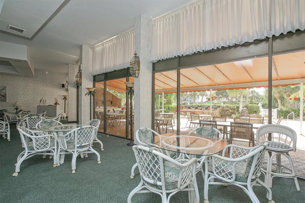5855 Midnight Pass Road, Unit 420 Sarasota, FL 34242 - Photo 33 of 53 a view of a dining room with furniture window and outside view