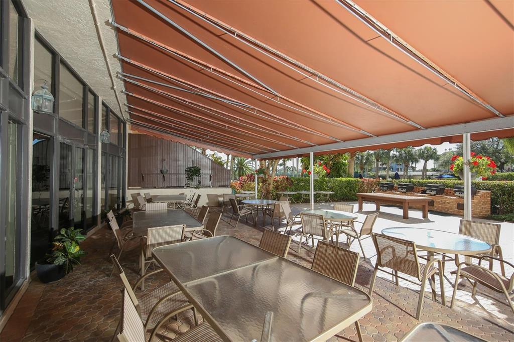 5855 Midnight Pass Road, Unit 420 Sarasota, FL 34242 - Photo 36 of 53 a view of a patio with couches table and chairs and potted plants
