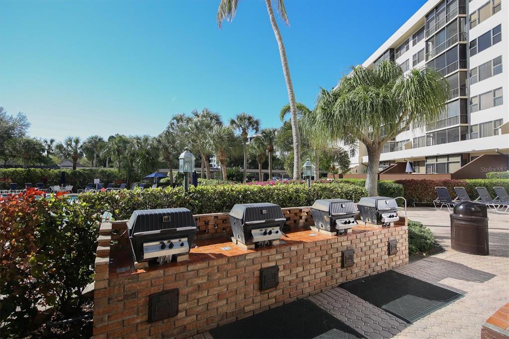 5855 Midnight Pass Road, Unit 420 Sarasota, FL 34242 - Photo 38 of 53 a view of a patio with couches table and chairs and potted plants