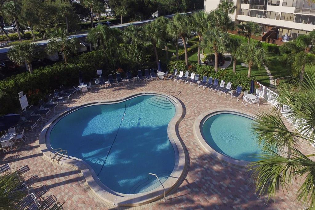 5855 Midnight Pass Road, Unit 420 Sarasota, FL 34242 - Photo 40 of 53 a view of a swimming pool with outdoor seating