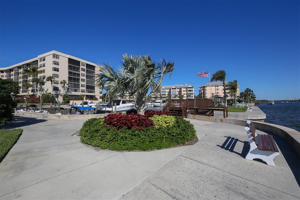 5855 Midnight Pass Road, Unit 420 Sarasota, FL 34242 - Photo 47 of 53 a view of a chairs and table in the backyard
