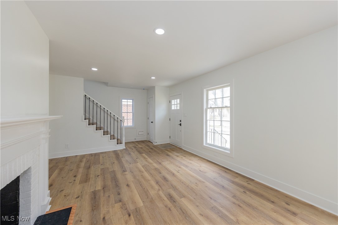 3694 Chelton Road Cleveland, OH 44120 - Photo 6 of 33 Entrance foyer with baseboards, a fireplace, recessed lighting, and stairway
