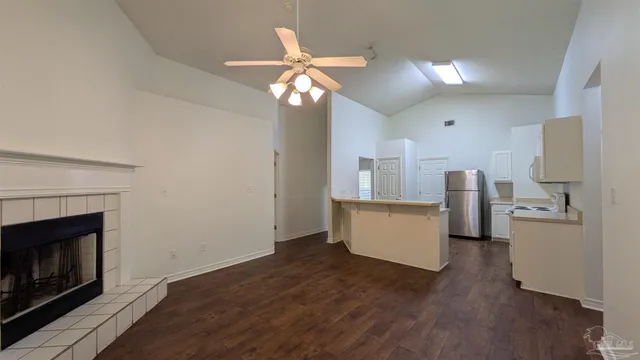 a kitchen with a sink cabinets and wooden floor